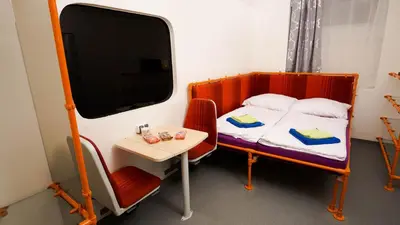 a small room with a bed and a small table at METRO Apartment Prague by Main Train and Bus Station in Prague