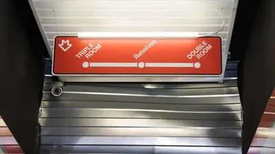 a red sign sitting on top of escalators at METRO Apartment Prague by Main Train and Bus Station in Prague
