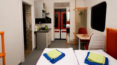 a room with two beds and a kitchen at METRO Apartment Prague by Main Train and Bus Station in Prague