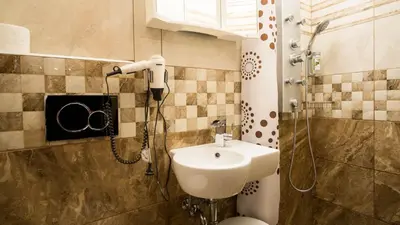 a bathroom with a shower with a sink and a toilet at METRO Apartment Prague by Main Train and Bus Station in Prague