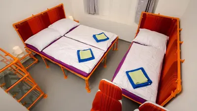 two bunk beds in a room with a chair at METRO Apartment Prague by Main Train and Bus Station in Prague