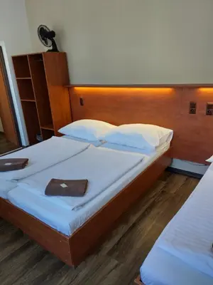 a bedroom with a large bed with a wooden headboard at Beta Pension in Prague