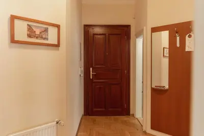 a hallway with a wooden door in a room at Sibelius Apartments Prague - Art Nouveau Residence 1902 in Prague