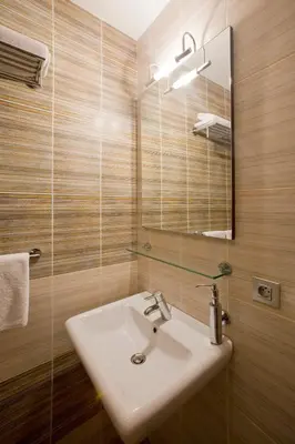 a bathroom with a sink and a mirror at Dahlia Inn in Prague