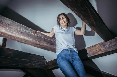 a woman is standing on a wooden beam at Residence Thunovska in Prague
