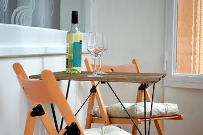 a table with a bottle of wine and a glass at GE Apartments in Prague
