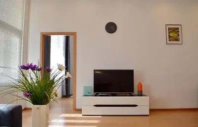 a living room with a tv on a white dresser at GE Apartments in Prague