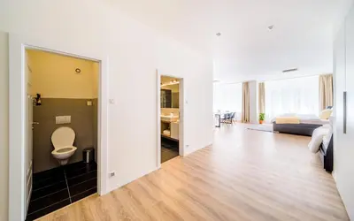 a living room with a toilet and a bedroom at Michal&Michael’s Central Apartments in Prague