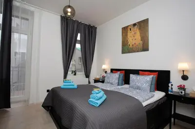 a bedroom with two beds with blue towels on them at Luxury apartment Spálená in Prague