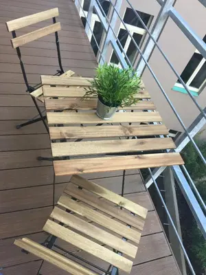 a wooden bench on a balcony with a plant at Luxury apartment Spálená in Prague
