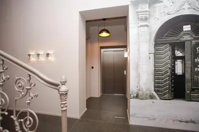 a hallway with a staircase leading to a door with a fireplace at Luxury apartment Spálená in Prague