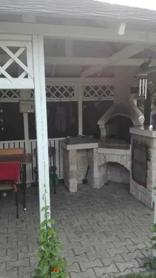a patio with an outdoor oven with a table at Homestay Svatá in Svatá