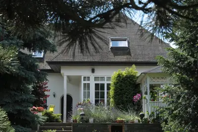 a white house with a window and flowers at Homestay Svatá in Svatá