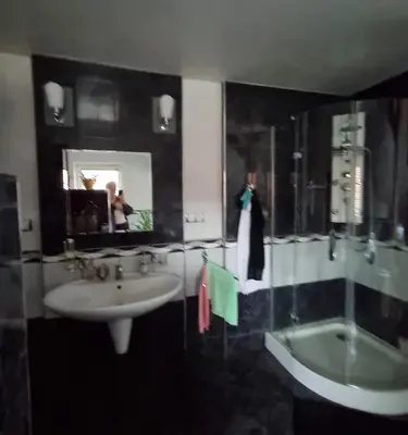 a bathroom with a sink and a bath tub at Homestay Svatá in Svatá