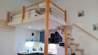a loft bed in a living room with a staircase at Jilská 449/14 in Prague