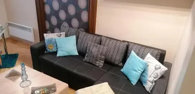 a black couch with pillows on it in a living room at Jilská 449/14 in Prague
