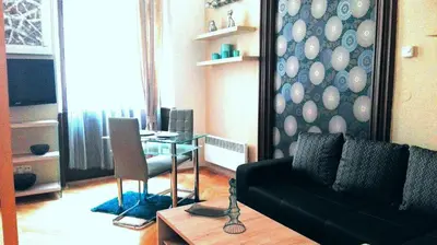 a living room with a black couch and a table at Jilská 449/14 in Prague
