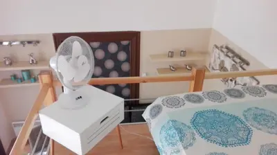 a room with a bed with a table with a fan at Jilská 449/14 in Prague