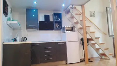 a kitchen with a staircase in a room at Jilská 449/14 in Prague
