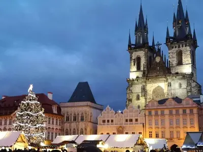 a city with a christmas tree in front of buildings at Apartment Hanspaulka Garden in Prague