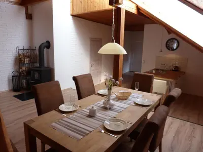 a wooden table with chairs and a dining room at Penzion Stranny in Stranný