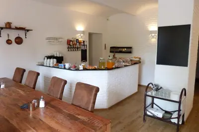 a dining room with a table and a bar at Penzion Stranny in Stranný