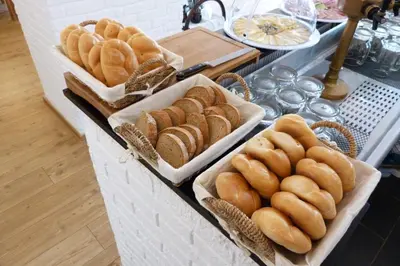 a buffet with several trays of bread on a table at Penzion Stranny in Stranný