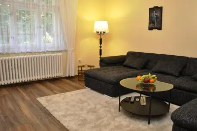 a living room with a couch and a table at Atmospheric Quiet Apartment in Prague