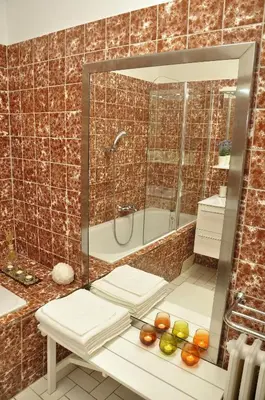 a bathroom with a shower and a tub and a sink at Atmospheric Quiet Apartment in Prague