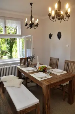 a dining room with a wooden table and chairs at Atmospheric Quiet Apartment in Prague