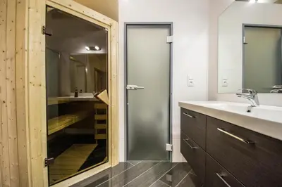 a bathroom with a shower and a sink at Brooklyn Sauna Apt by Ruterra in Prague