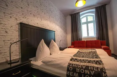 a bedroom with a bed and a brick wall at Brooklyn Sauna Apt by Ruterra in Prague