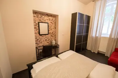 a bedroom with a bed and a brick wall at Brooklyn Sauna Apt by Ruterra in Prague