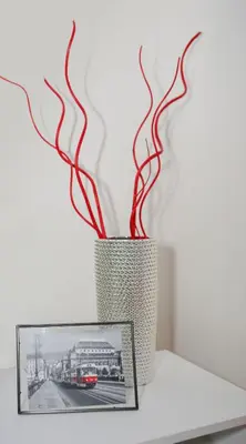 a vase sitting on a table next to a picture at Stylish apartment a few steps from metro in Prague