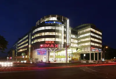 a large building with a sign on it at night at Stylish apartment a few steps from metro in Prague