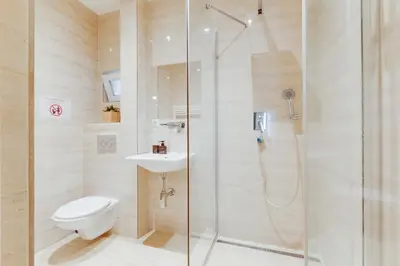 a bathroom with a shower with a toilet and a sink at Modern Quiet Apt next to Wenceslas Square - VS in Prague