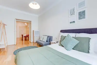 a bedroom with a large bed and a couch at Modern Quiet Apt next to Wenceslas Square - VS in Prague