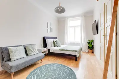 a living room with a couch and a bed at Modern Quiet Apt next to Wenceslas Square - VS in Prague