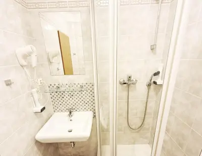 a bathroom with a sink and a shower at Relax Inn in Prague