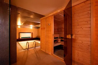 a bathroom with a tub and wooden walls at Relax Inn in Prague