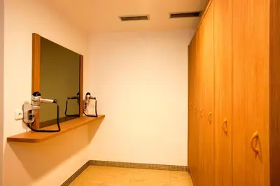 a room with a mirror on the wall and a shelf at Relax Inn in Prague