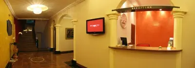 a lobby with a reception desk in a building at Relax Inn in Prague