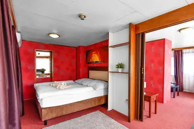 a bedroom with a bed in a red room at Botel Vodnik in Prague