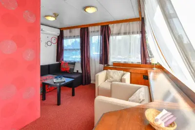 a living room with a couch and a table at Botel Vodnik in Prague