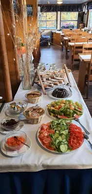 a table with many plates of food on it at Botel Vodnik in Prague