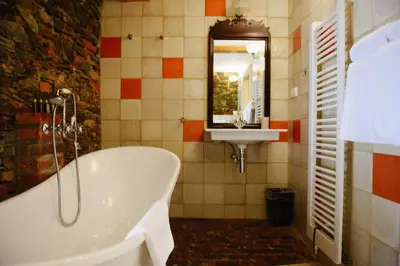 a bathroom with a tub and a sink at Savoia Castle in Škvorec