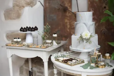 a table with a wedding cake and other desserts at Savoia Castle in Škvorec