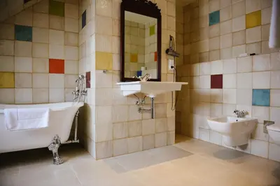 a bathroom with a sink and a tub and a toilet at Savoia Castle in Škvorec