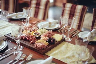 a wooden table with a plate of food on it at Savoia Castle in Škvorec
