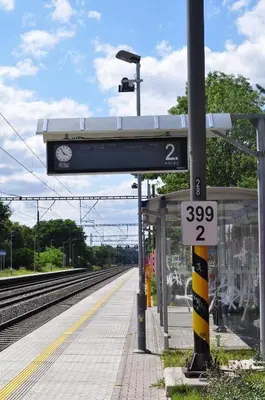 a train station with a sign at a train station at Hotel Svornost in Prague